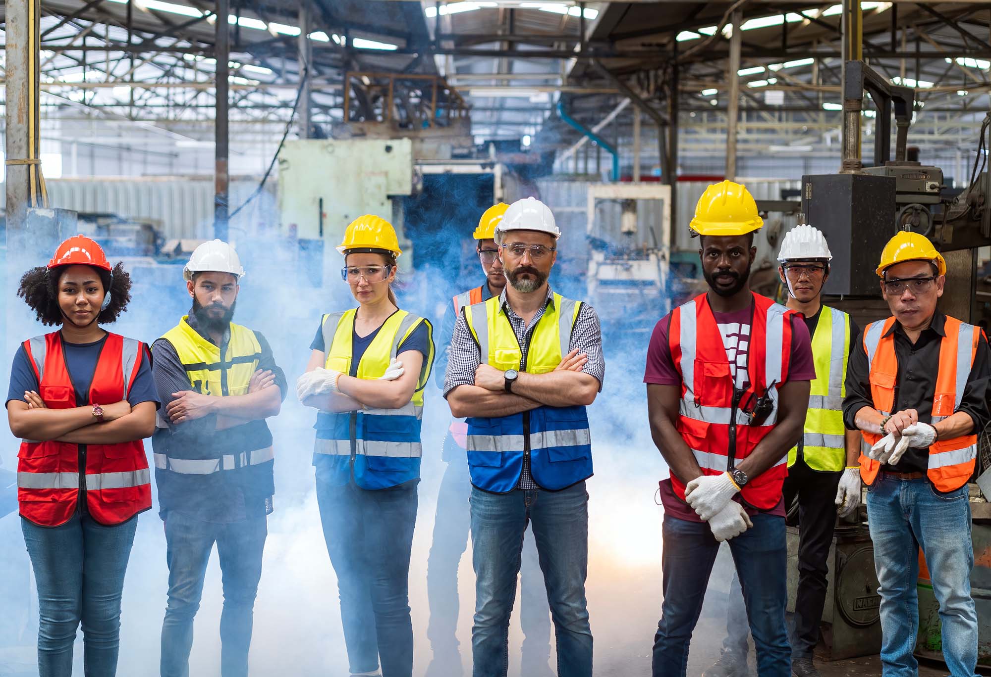 Construction workers in hard hats and high-visibility vests standing in a row