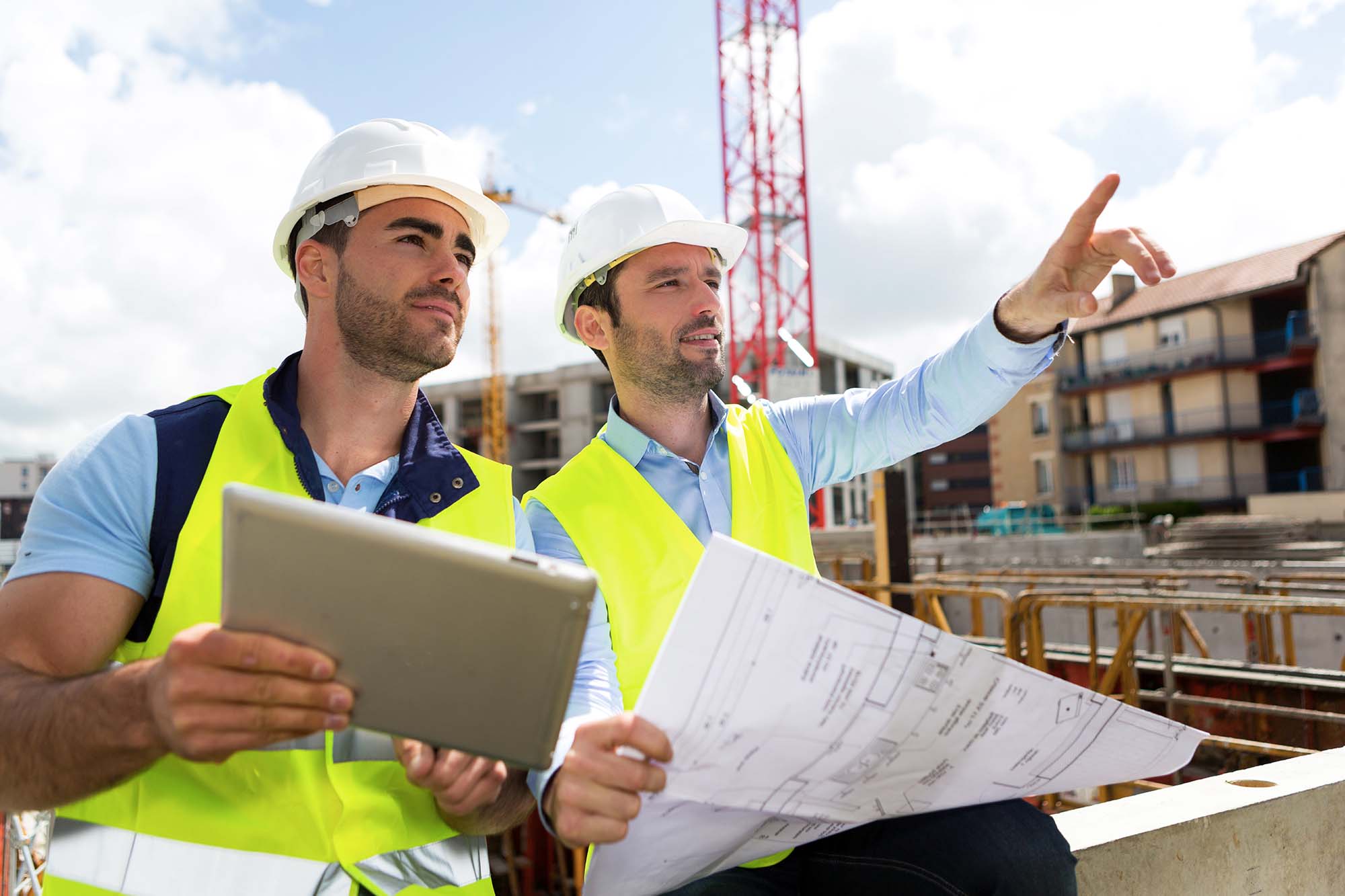 Construction architect on-site reviewing schematics